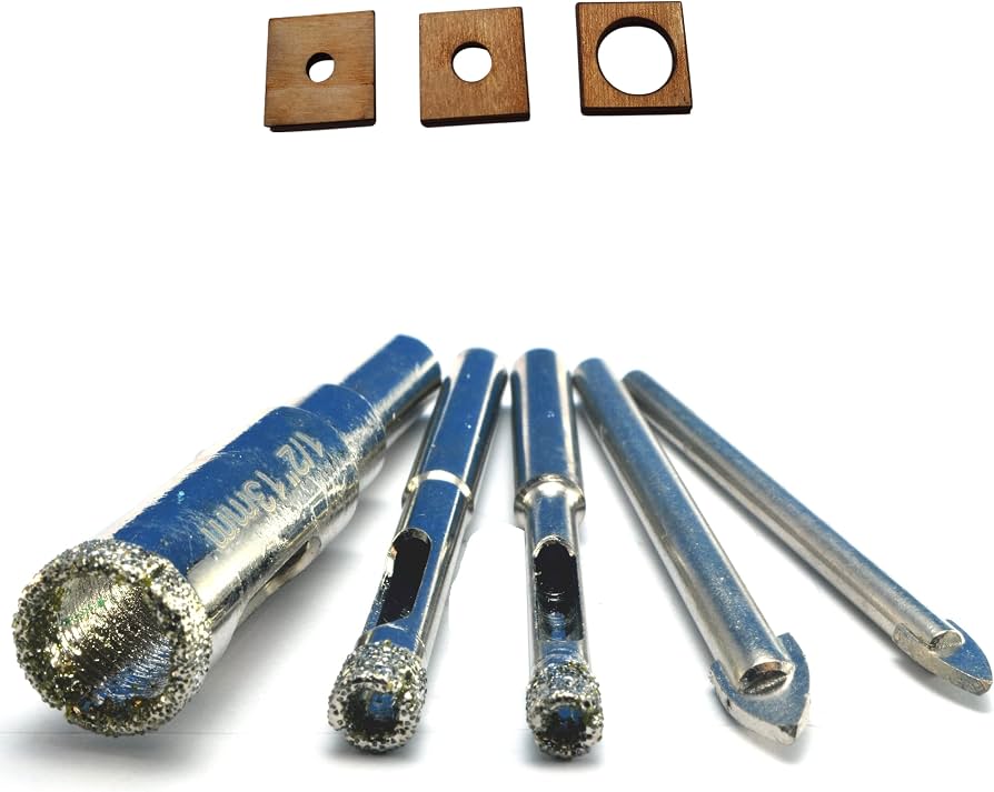A diamond tile drill bit positioned on a ceramic tile with masking tape used to prevent slipping
