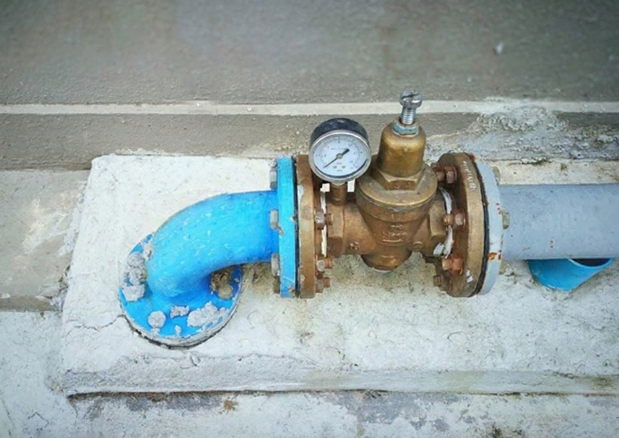 A pressure-reducing valve installed on a home's main water line near the water meter