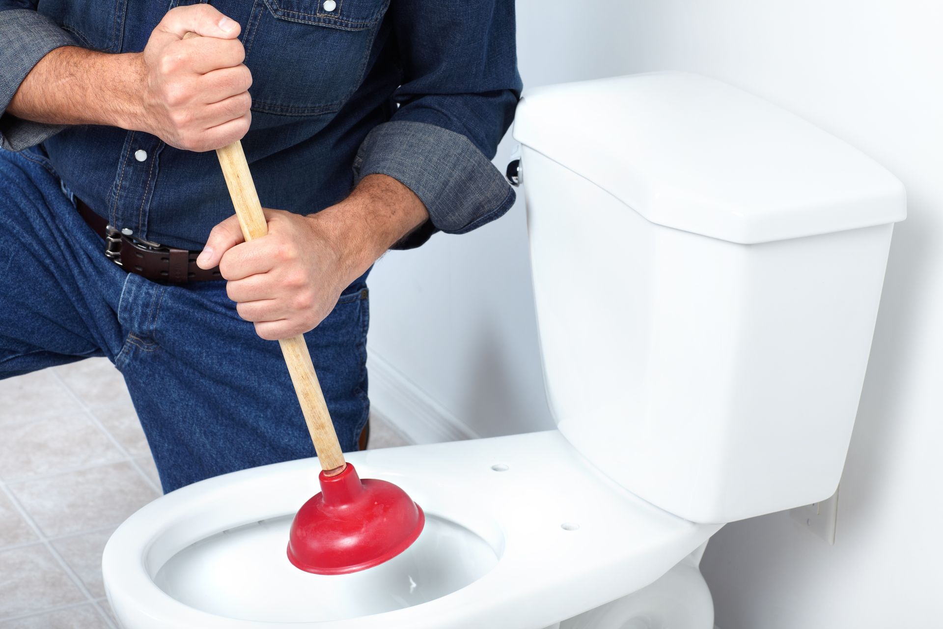 A real bathroom photo showing a toilet bowl with water sitting higher than normal and draining slowly after a flush